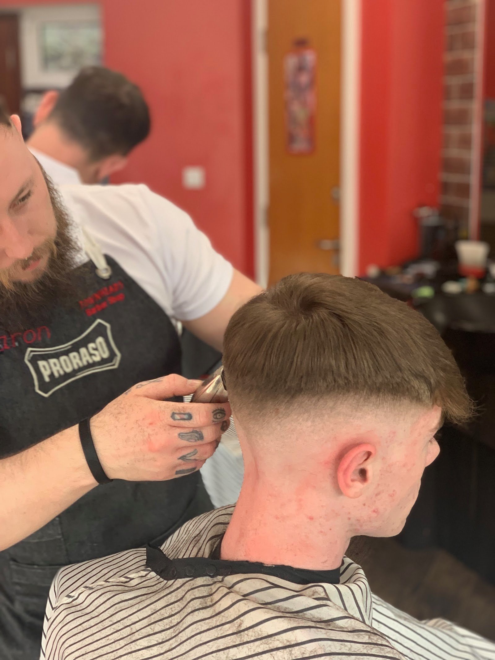 Barber finishing a skin fade at Town Heads